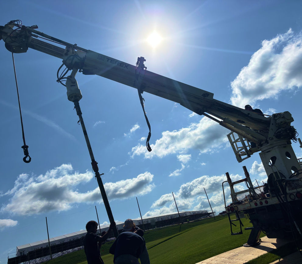 Custom golf course netting system installation team