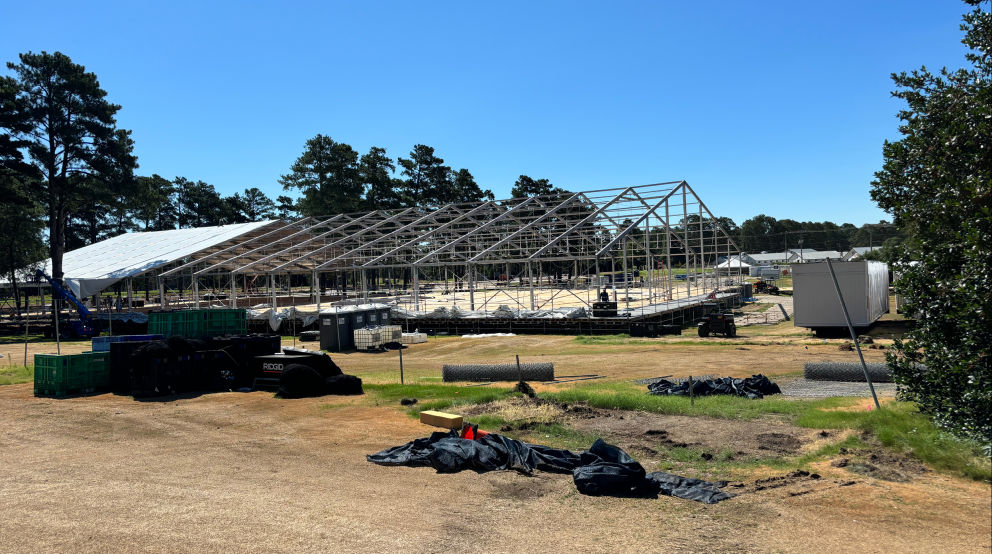 “Large-scale sports netting structure under construction by Nets of Texas, showing steel framework for a covered driving range enclosure.